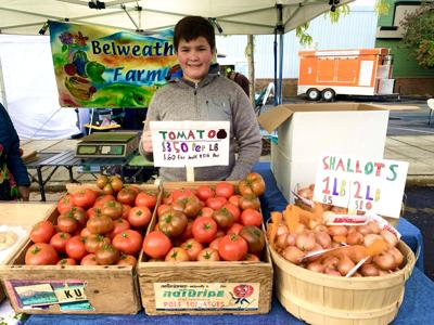 Jacob Culp works his family's stand at Klamath Farmers Market 2023